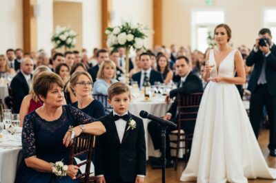 At my brother’s wedding, his bride publicly disrespected me in front of everyone. But before I could react, my 9-year-old son quietly took the microphone—and what he said next changed everything./th